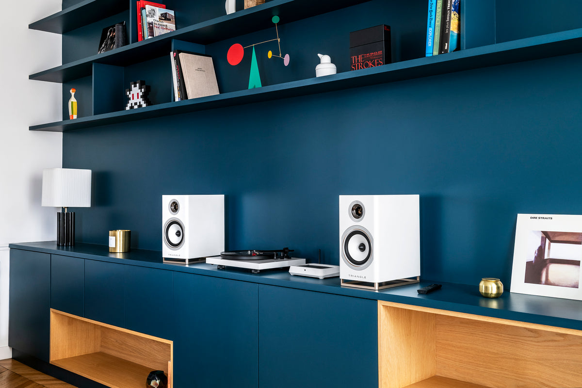 Enceintes Capella bleues et platine sur une console